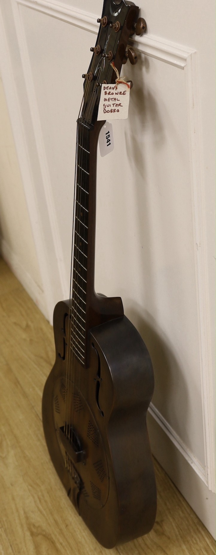 A Dean Resonator Heirloom guitar, bronzed finish, with soft case, 100cms high.